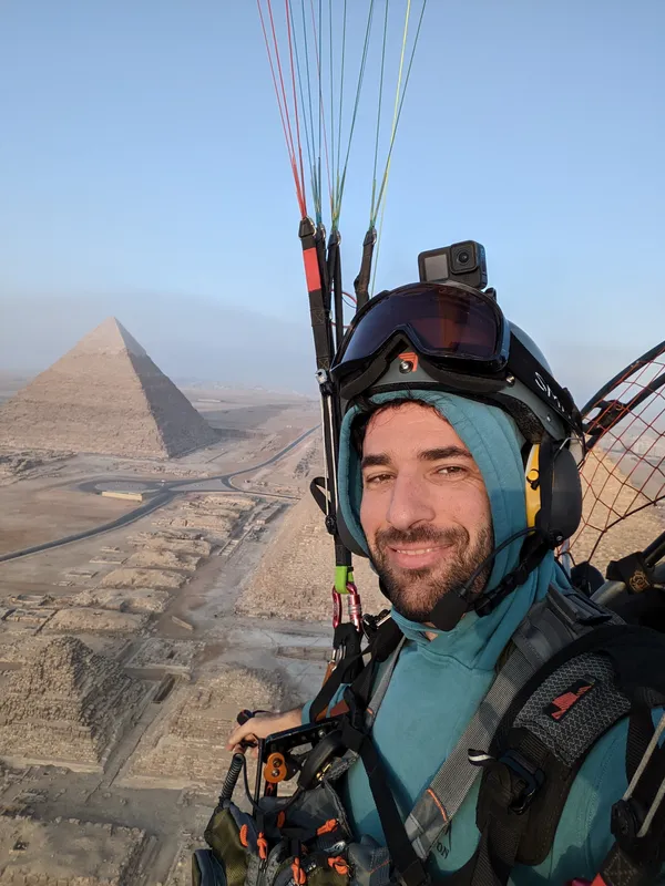 Nimo flying a paramotor next to the Great Pyramid of Giza