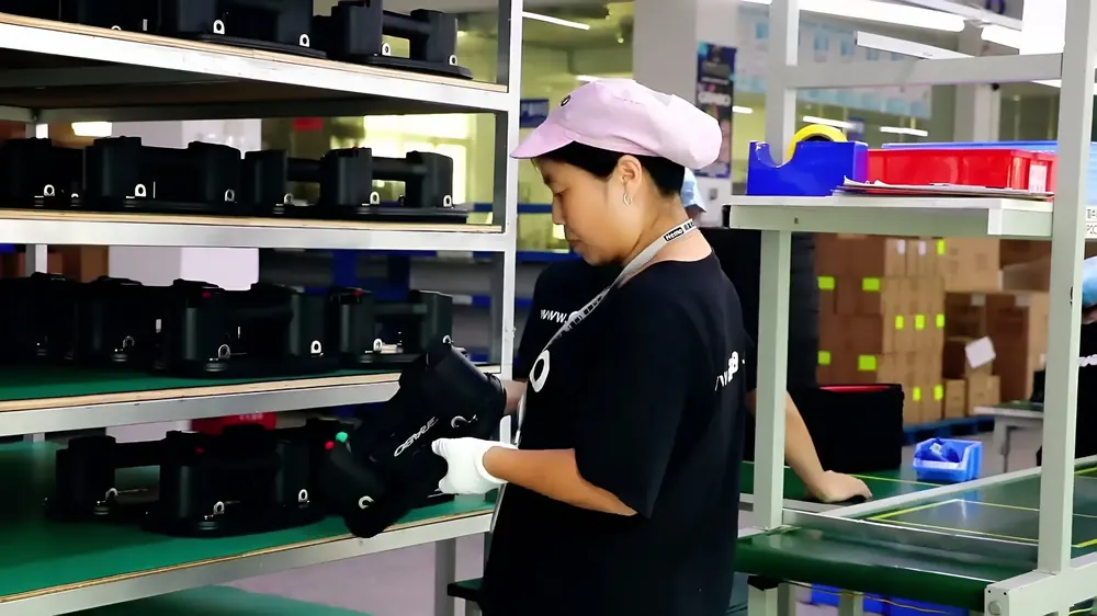 A technician checking finished lifters on test racks