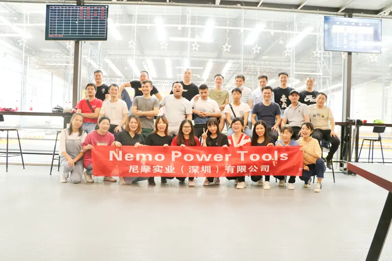 The team on an outing behind a Nemo Power Tools banner