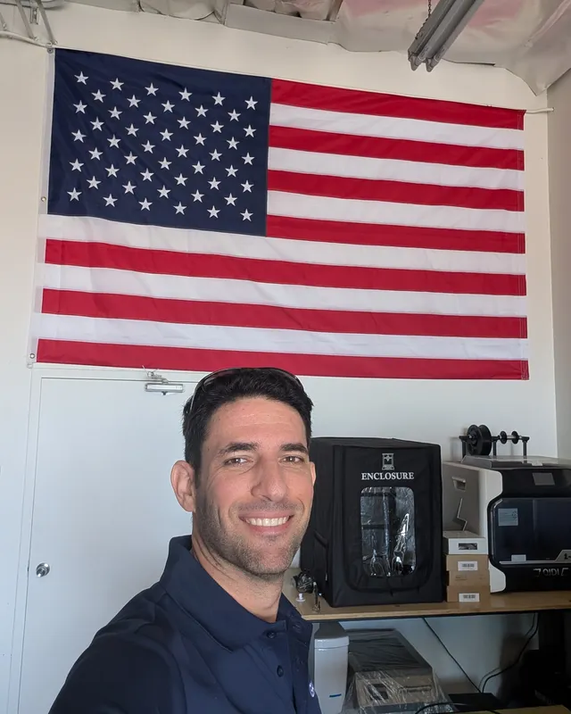 A selfie in the Las Vegas office under a large American flag
